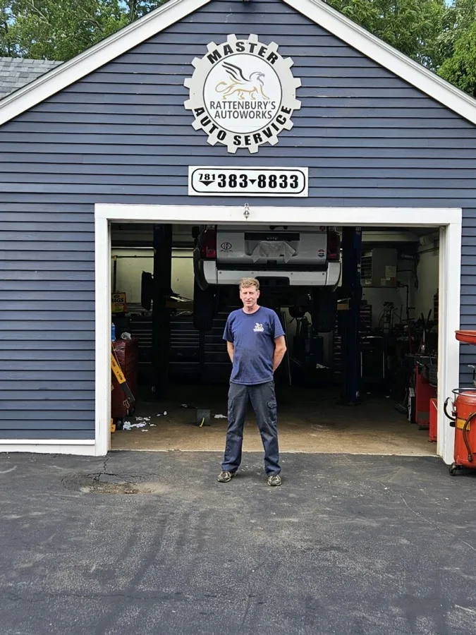 Owner of Rattenbury's Auto Works standing in the garage bay